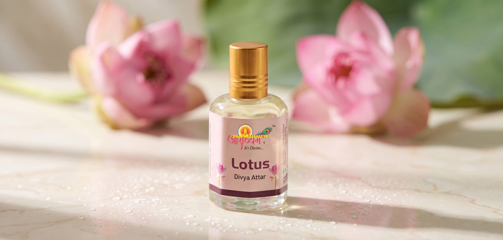 Aradhyam lotus attar bottle on marble with pink lotus